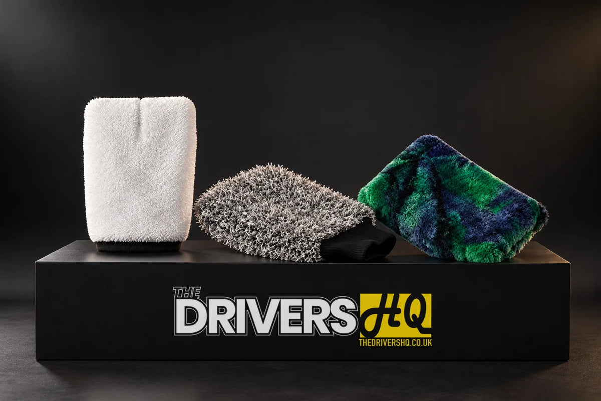 Purestar white Interior Wash Mitt, grey Double Twist Wash Mitt and dark green Colour Pop Wash Pad on a black display plinth