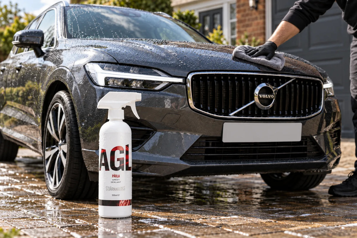 Stjarnagloss Parla spray sealant 500ml on a wet driveway in front of a dark grey Volvo XC60 being buffed with a microfibre cloth