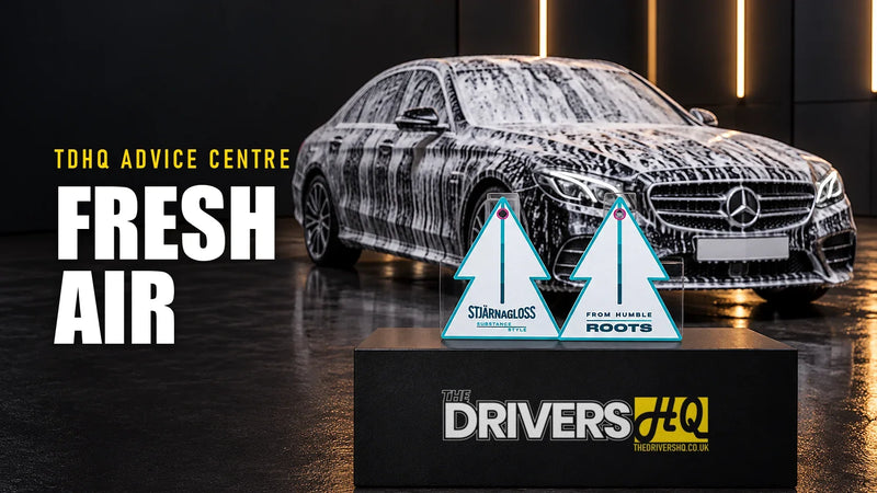 Best car air freshener UK: Stjarnagloss Roots hanging air freshener cards on The Drivers HQ display plinth in front of a black Mercedes E-Class covered in snow foam