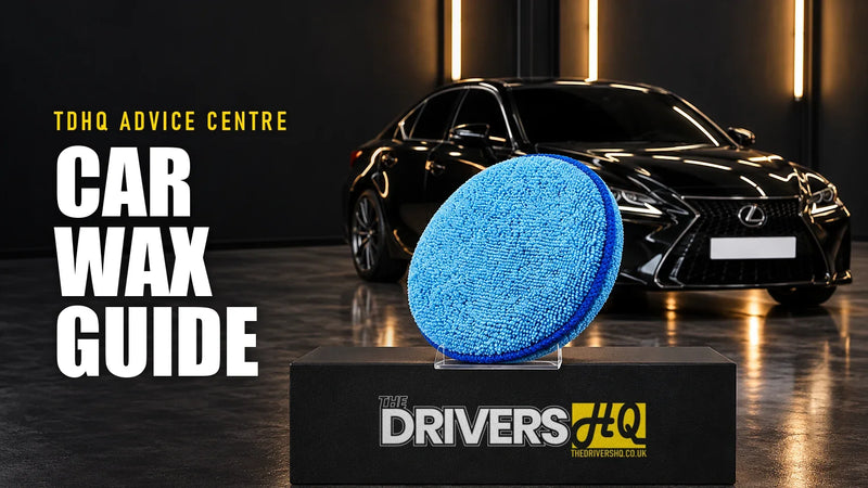 Car wax guide: a microfibre foam wax applicator pad on The Drivers HQ display plinth in front of a black Lexus IS