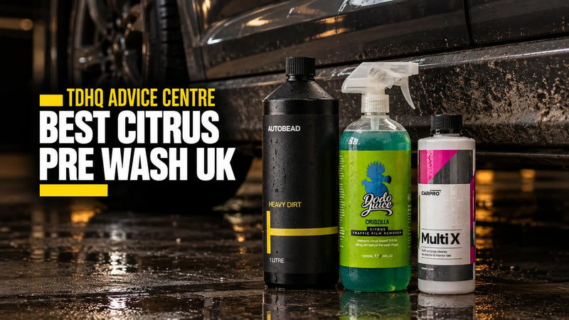AutoBead Heavy Dirt, Dodo Juice Crudzilla and CarPro Multi X beside the dirty sill of a dark grey car on a wet garage floor