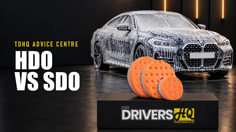 Lake Country HDO vs SDO pads: orange Lake Country CCS polishing pads on The Drivers HQ display plinth in front of a blue BMW 4 Series covered in snow foam