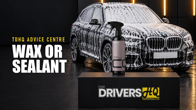 Wax vs sealant vs ceramic coating: AutoBead Ceramic Quick Detailer on The Drivers HQ display plinth in front of a black BMW X3 covered in snow foam