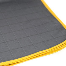FibreKing Carbon Glass Cloths, close up of stacked cloths showing the grid pattern and yellow edges