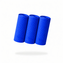 FibreKing Waffle Weave glass towels in blue, three towels rolled up showing the waffle texture