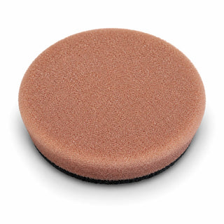 Autobead Downforce Heavy Cut 3 inch foam polishing pad in tan brown with a black hook and loop backing, studio photo on white