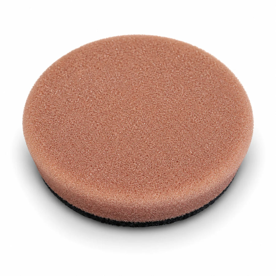 Autobead Downforce Heavy Cut 3 inch foam polishing pad in tan brown with a black hook and loop backing, studio photo on white