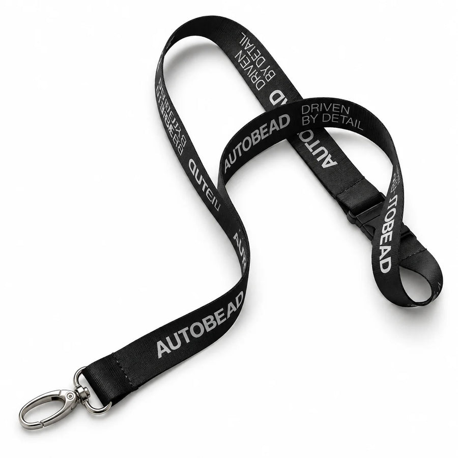 Autobead black lanyard printed AUTOBEAD and DRIVEN BY DETAIL with a silver swivel clip, studio photo on white