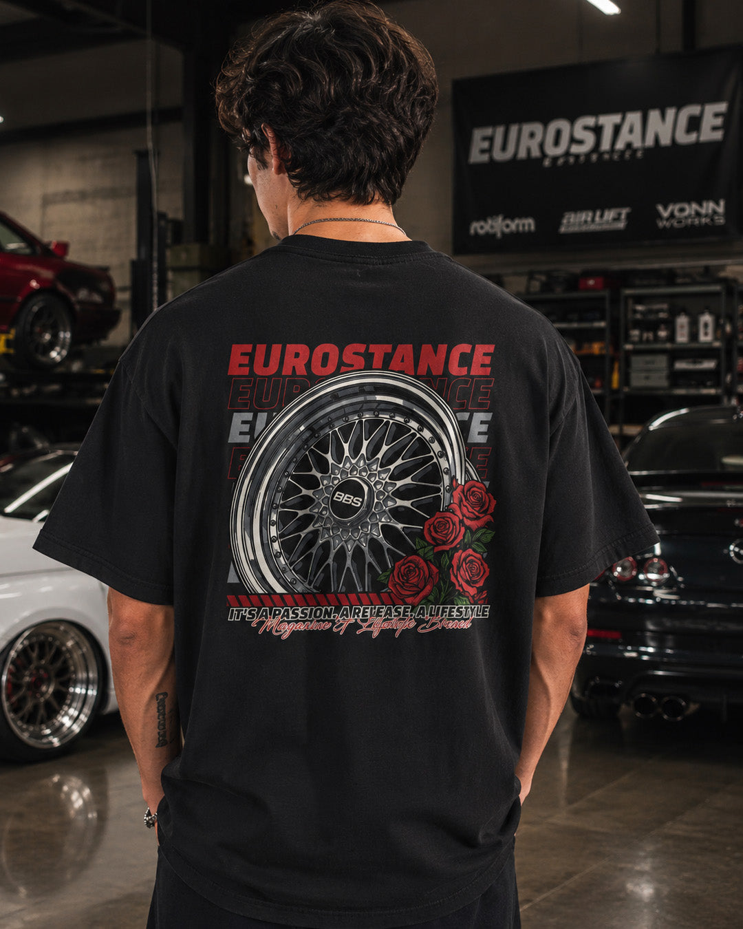 EuroStance BBS & Roses T-Shirt in black, back print worn by a model in a garage
