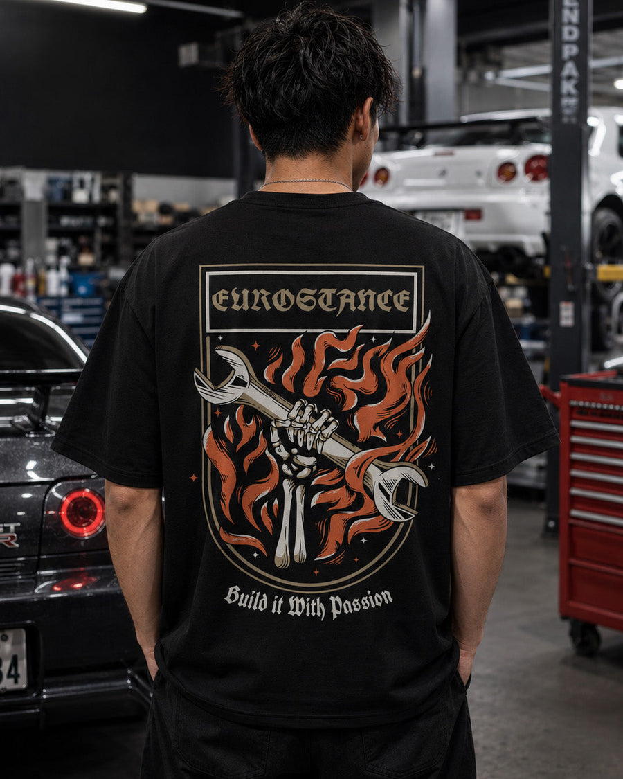 EuroStance Build it with passion Tee worn in a workshop, back flaming spanner print