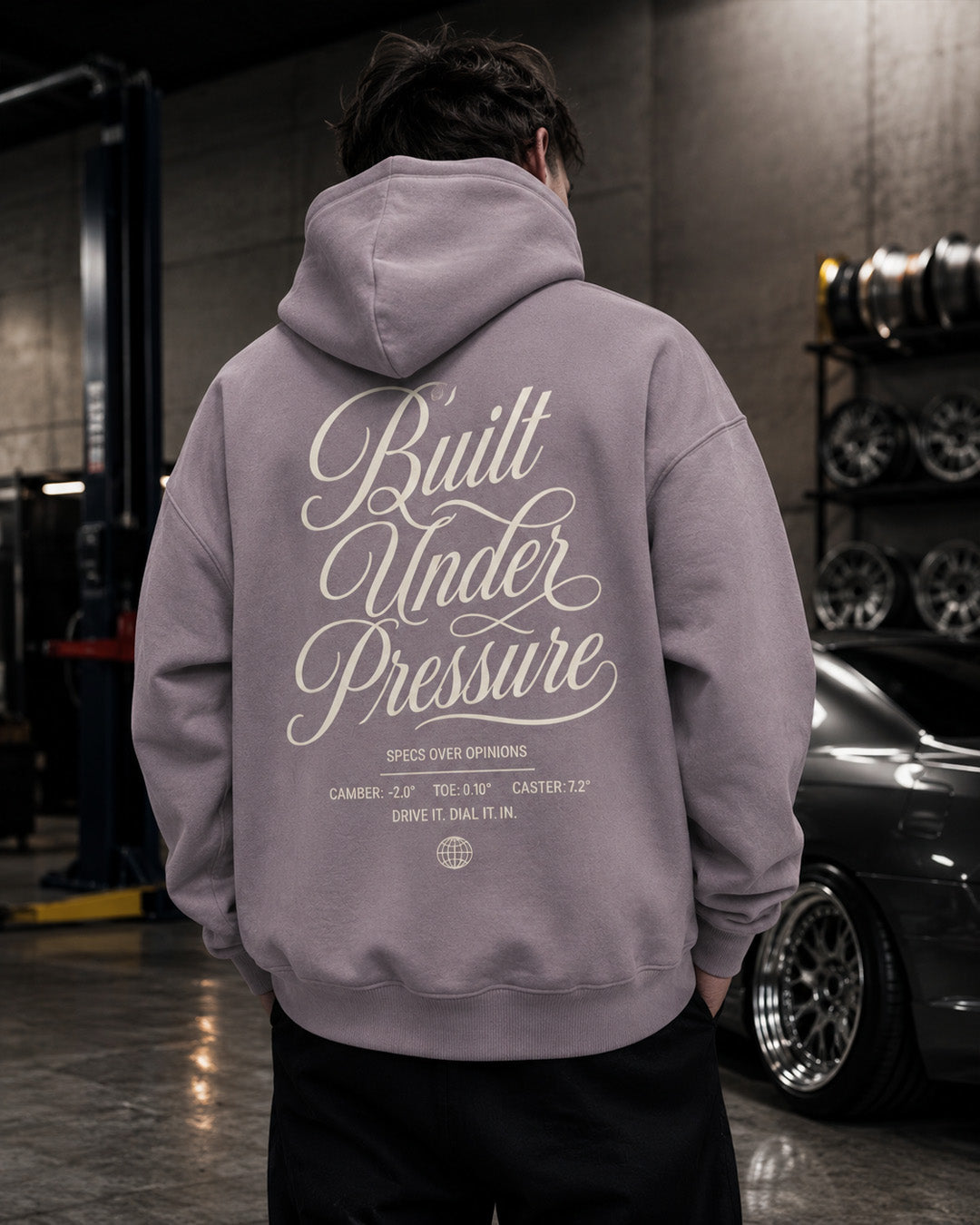 EuroStance Built Under Pressure Hoodie in dusty purple, back print beside a rack of wheels