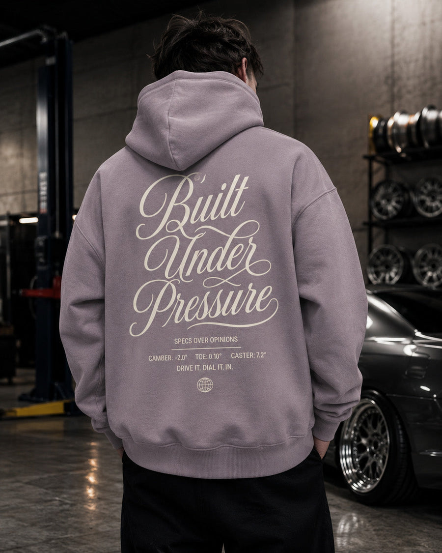 EuroStance Built Under Pressure Hoodie in dusty purple, back print beside a rack of wheels