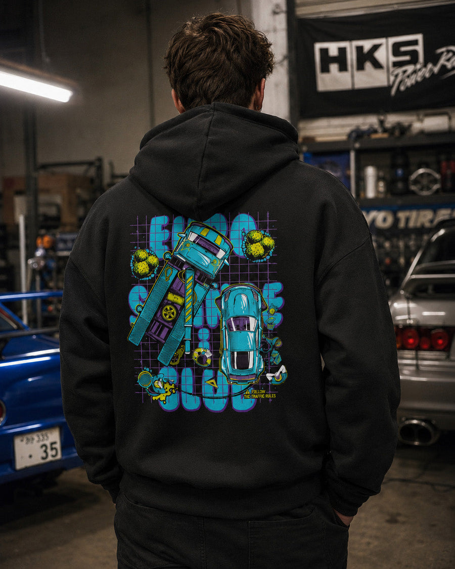 EuroStance Stance Club Crashed Hoodie in black worn in a workshop, teal cartoon car back print