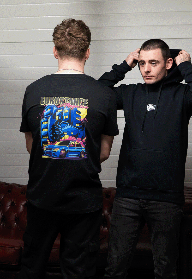 EuroStance Locally Hated BMW Tee back print worn beside a model in a black logo hoodie