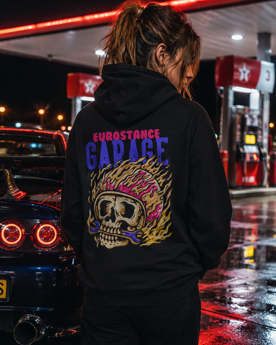 EuroStance Garage Fire Caffine Hoodie on a woman at a petrol station, flaming skull back print