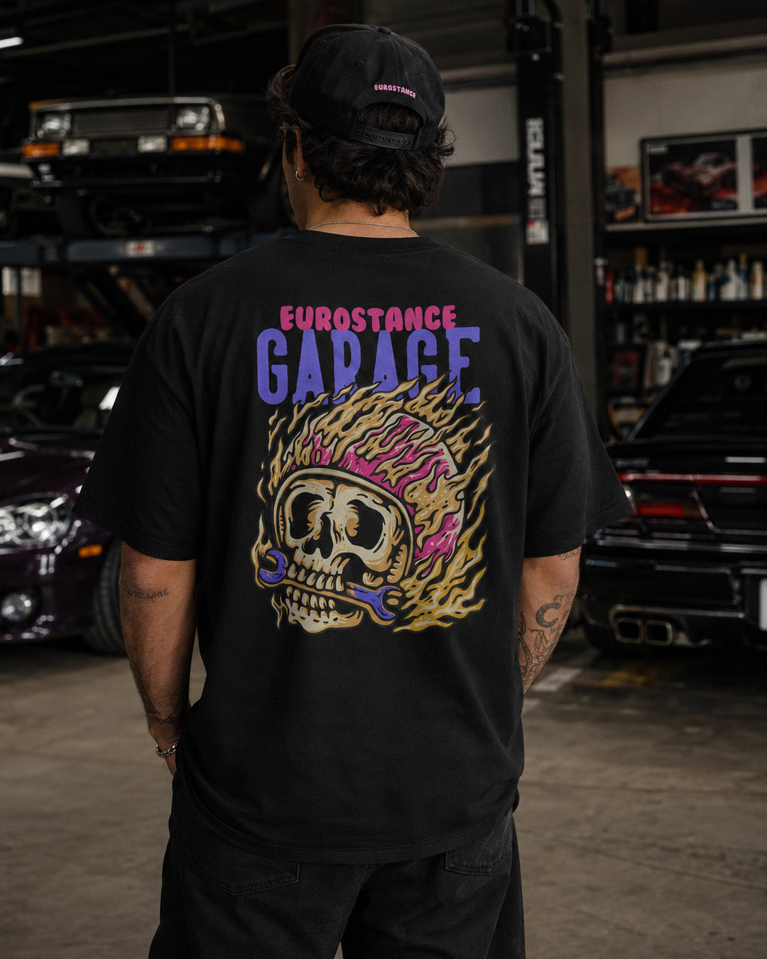 EuroStance Garage Fire Caffine Tee back print of a flaming skull, worn in a workshop