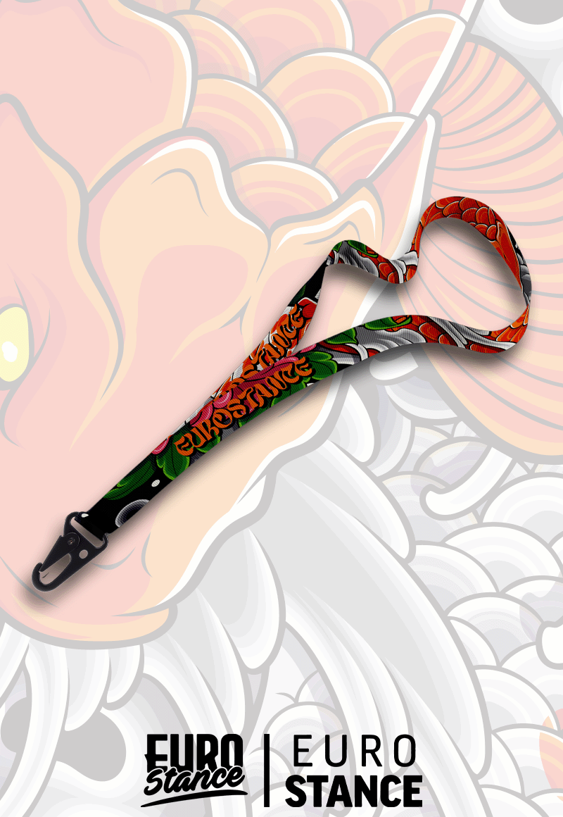 EuroStance Koi JDM Lanyard with orange and green koi print and black clip, on koi artwork