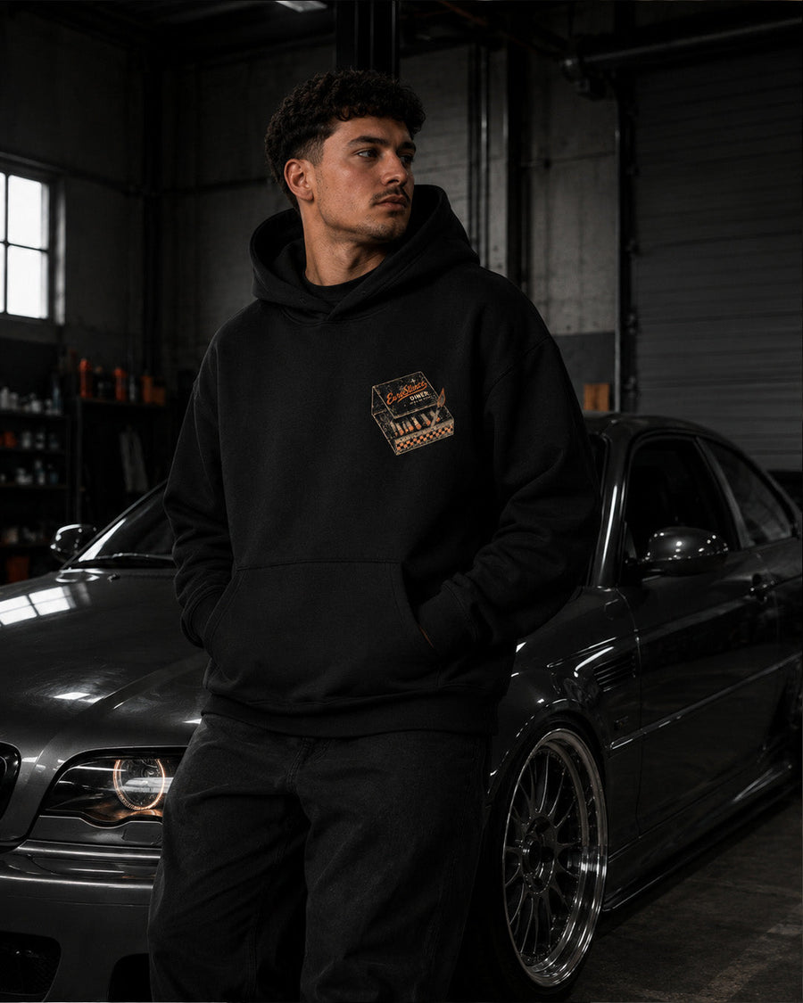 EuroStance Last Stop Hoodie on a model by a car, front with small matchbook chest print
