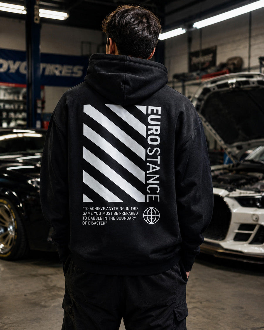 EuroStance OffStance Stirling Moss Hoodie black back on a model in a car workshop