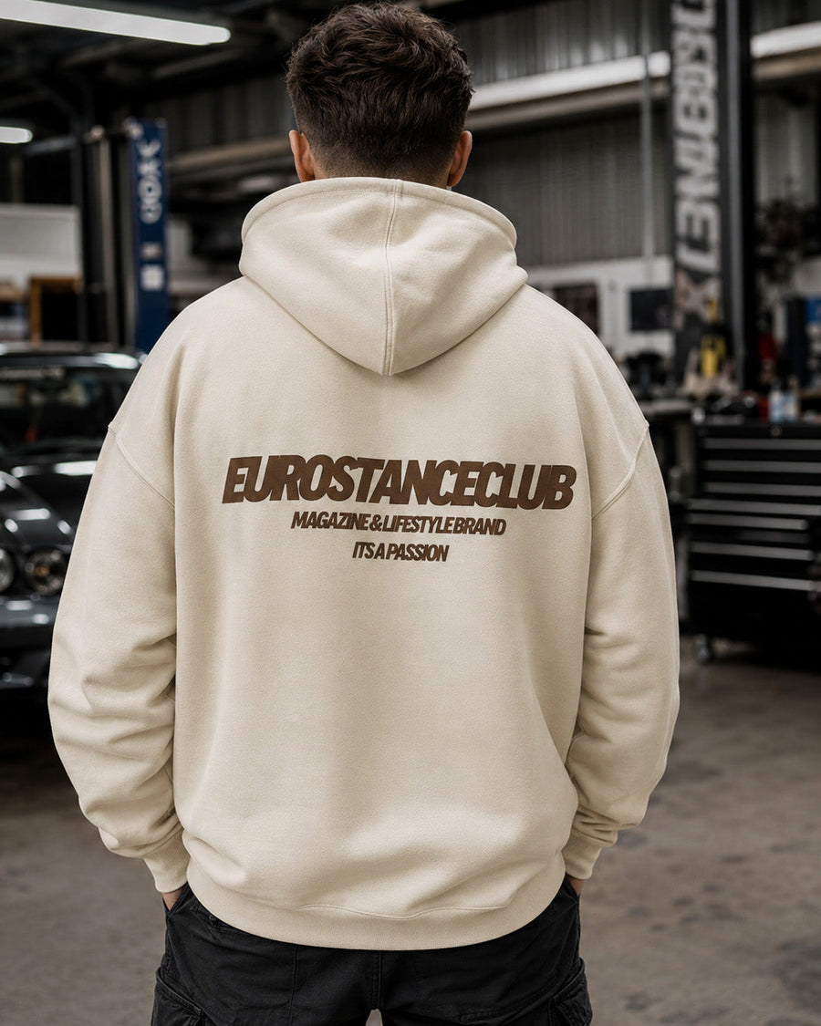 EuroStance Club Lifestyle Hoodie, sand hoodie with brown back print worn in a car workshop