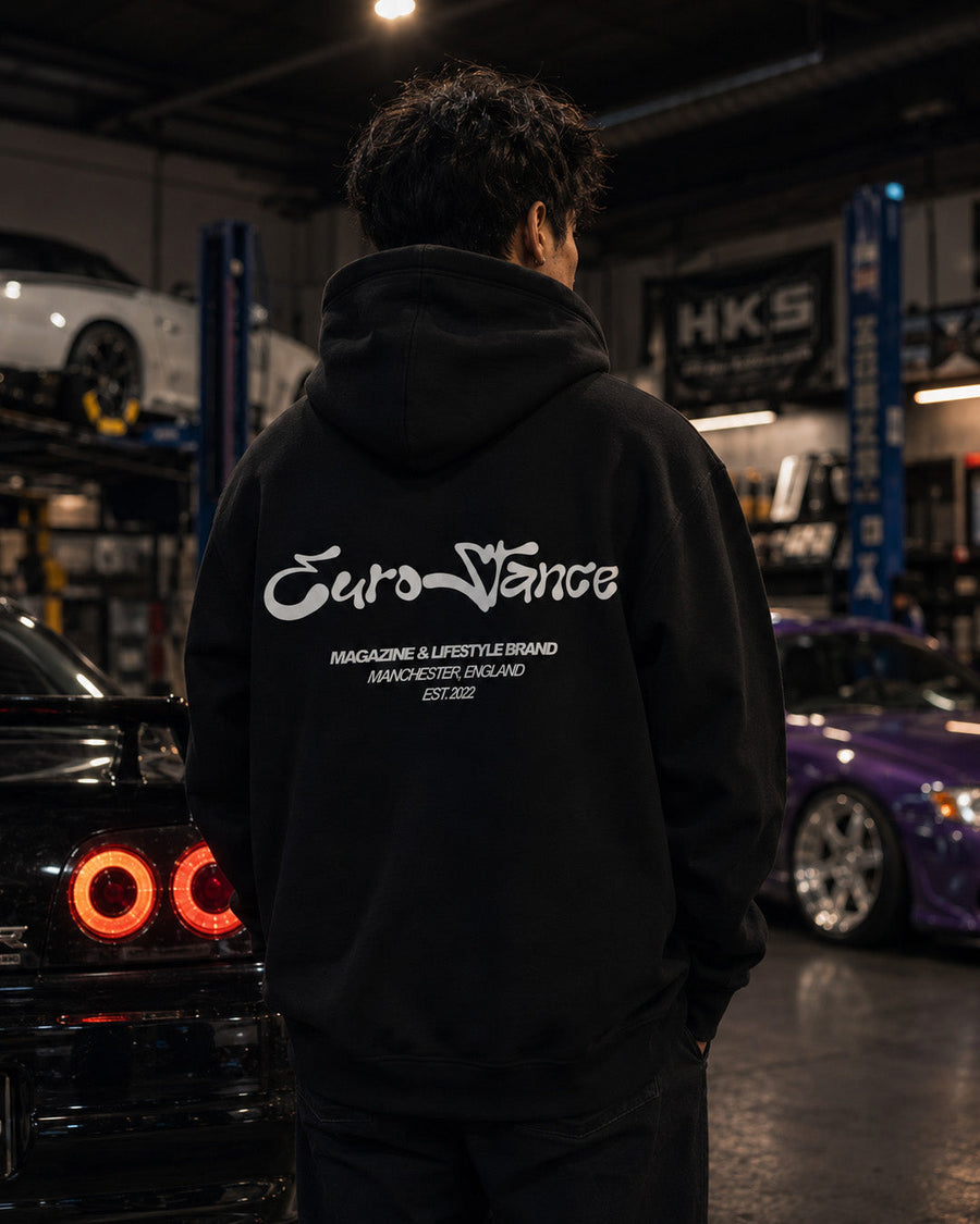 EuroStance Lifestyle Script Oversized Hoodie, back of the black hoodie worn in a garage
