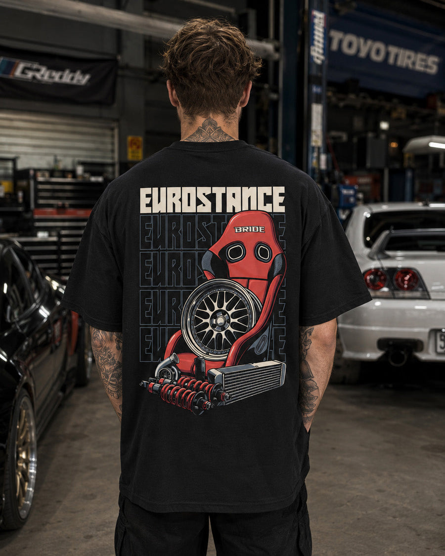 EuroStance Race Parts T-shirt worn in a garage, back print of red bucket seat and wheel