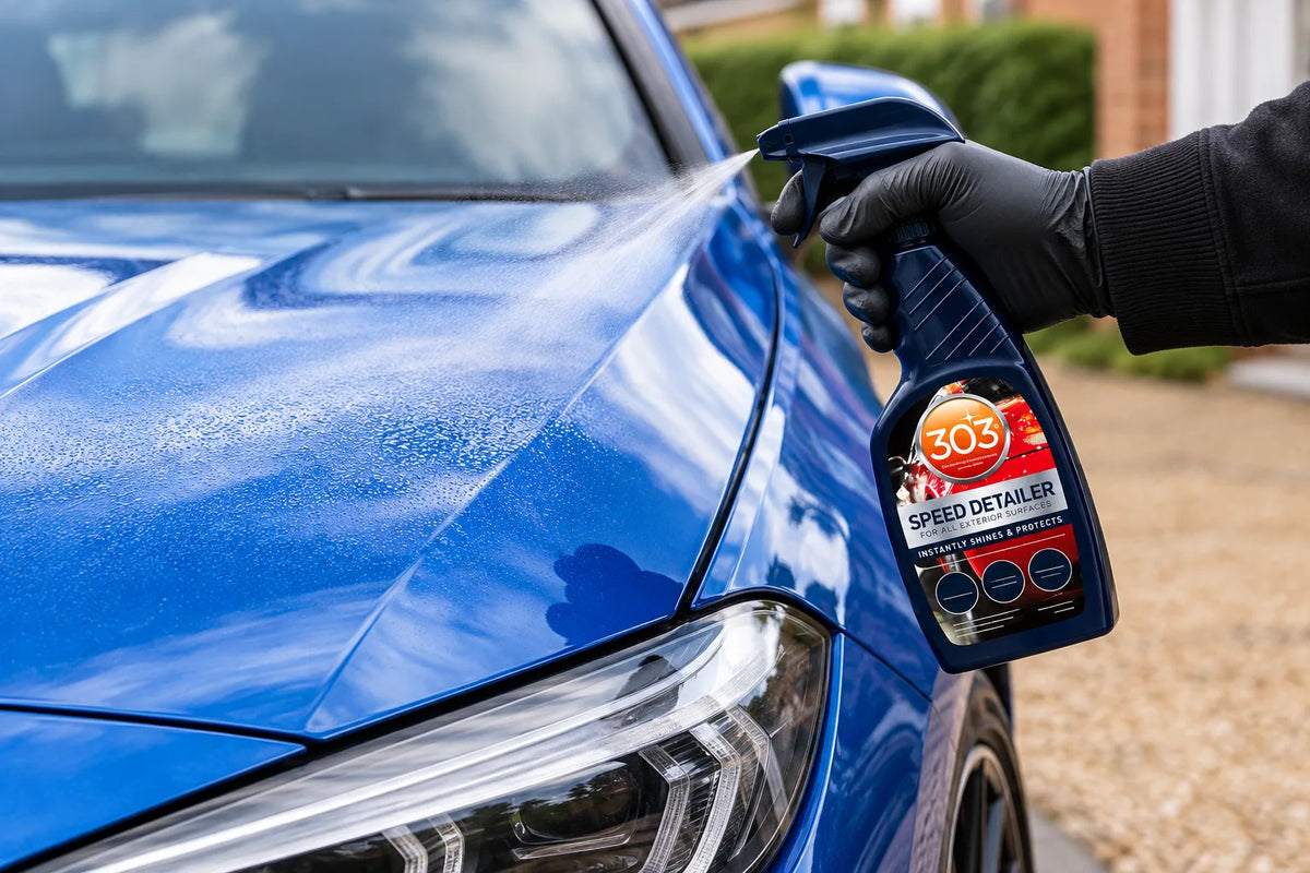303 Speed Detailer being sprayed onto the bonnet of a blue car on a driveway