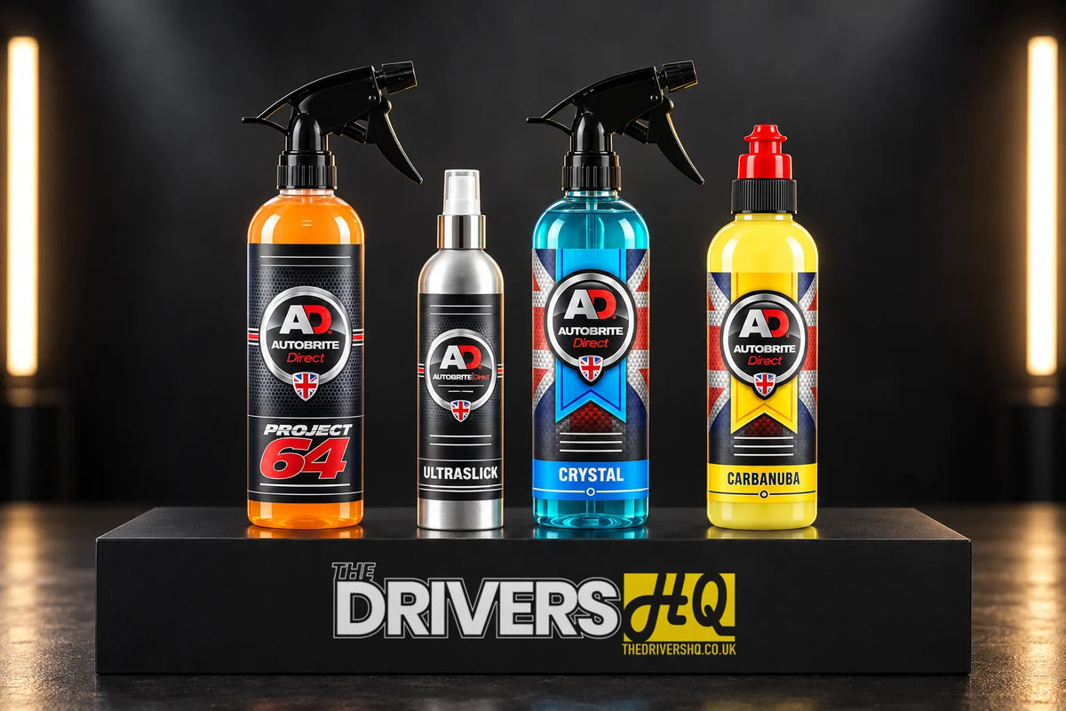 Autobrite Direct Project 64 Spray Gloss Enhancer, Ultraslick Paint Sealant, Crystal Glass Cleaner and Carbanuba Car Wax bottles on a black display plinth