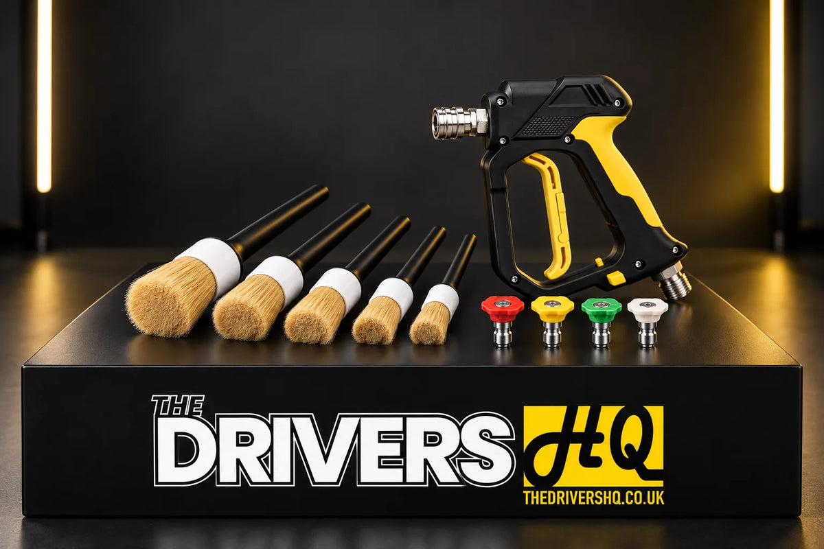 Better Detailing boar hair detailing brushes, stubby trigger gun and quick release nozzle set on a black display plinth in a photo studio