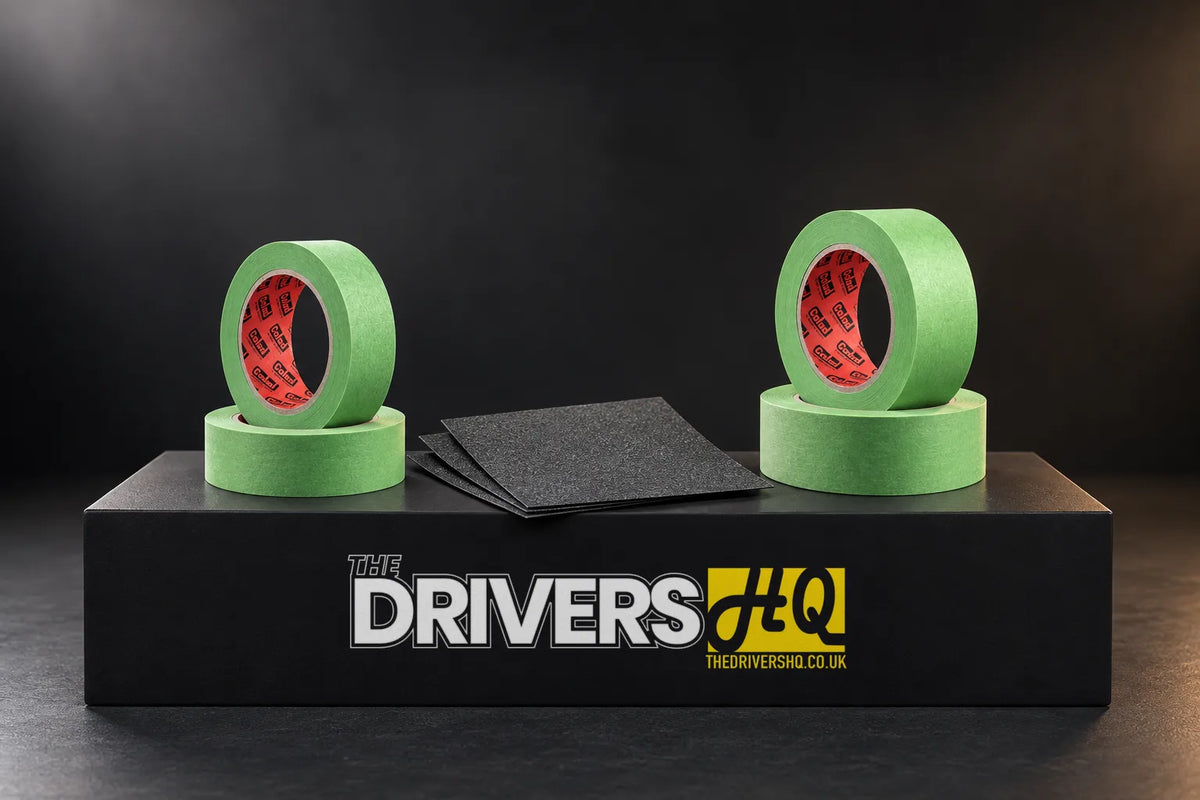Colad Aqua Dynamic green masking tape rolls and black 1500 grit waterproof sanding sheets on a black display plinth