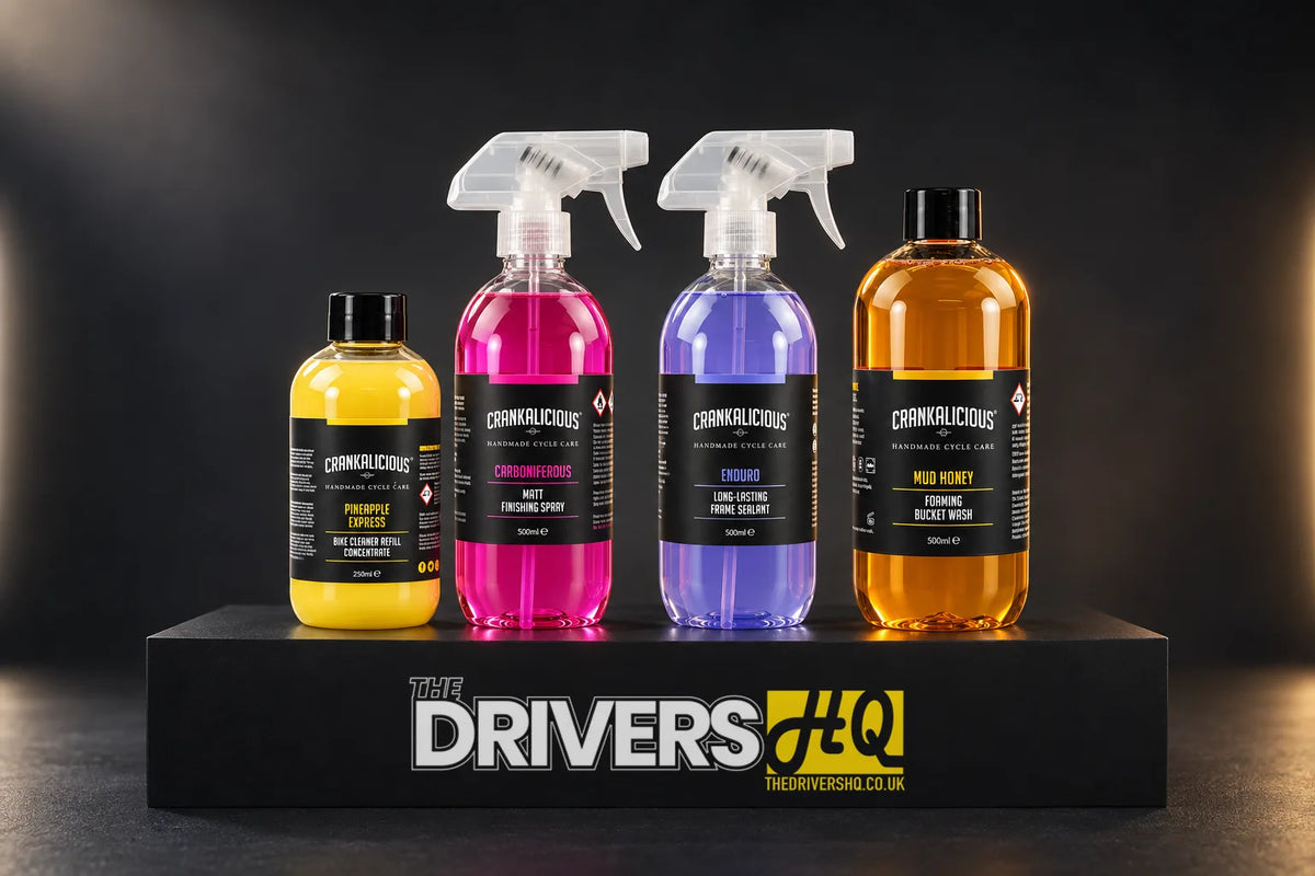Crankalicious Pineapple Express, Carboniferous, Enduro and Mud Honey bike care bottles on a black display plinth