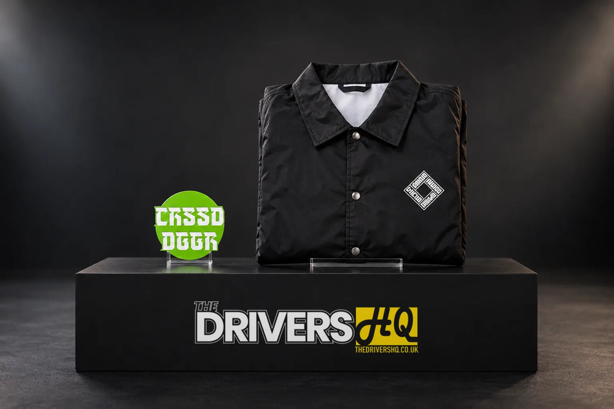 Crossed Dagger Apparel green CRSSD DGGR sticker and folded black CDA coach jacket on a black display plinth