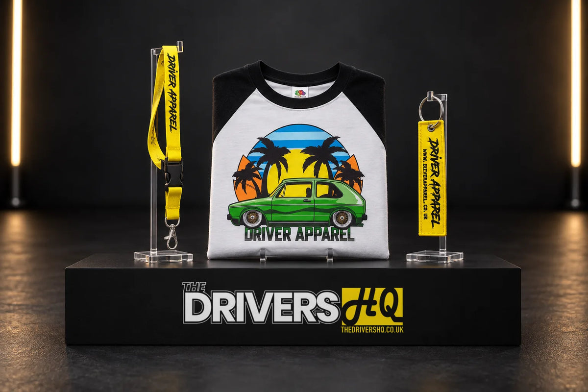 Driver Apparel Golf baseball tee, yellow lanyard and yellow flight tag key chain on a black display plinth