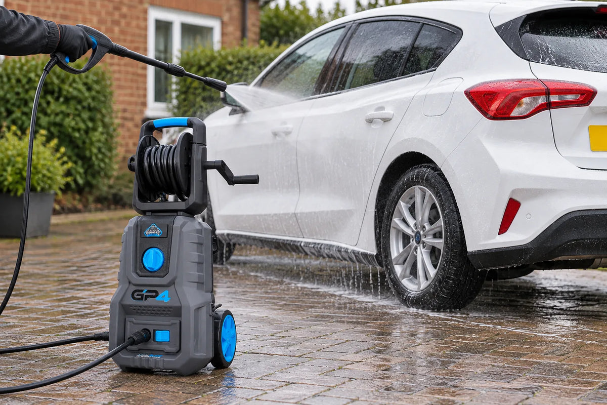 Gorilla Power GP4 pressure washer rinsing a white Ford Focus on a wet block paved driveway