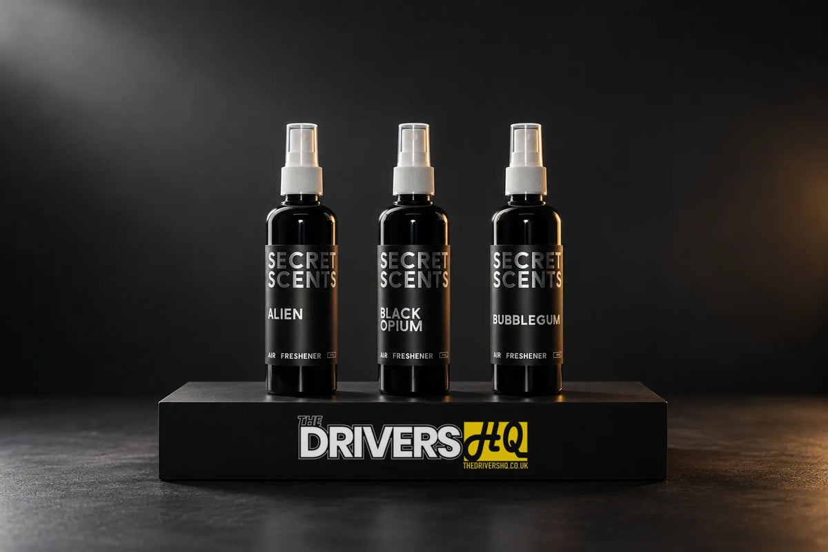 Secret Scents Alien, Black Opium and Bubblegum air freshener sprays on a black display plinth