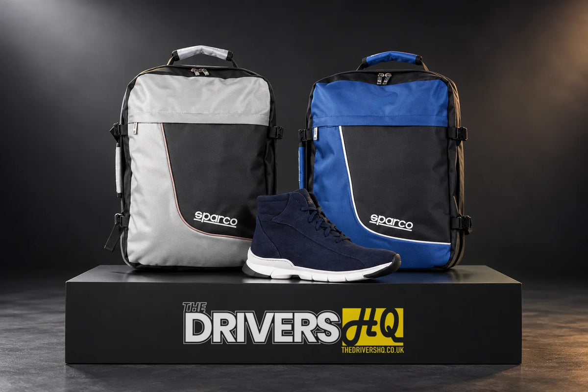 Sparco large grey and large blue backpacks with navy Monza Lesmo ankle boot trainers on a black display plinth