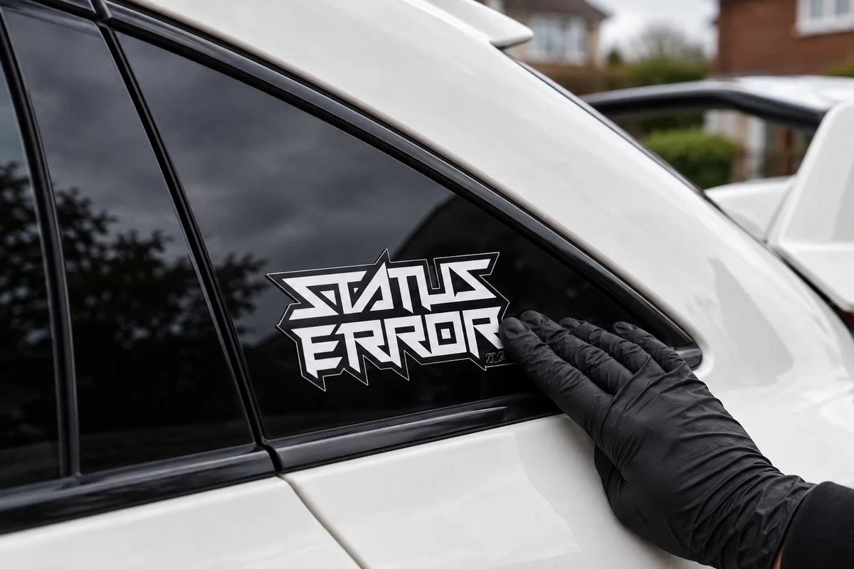 Status Error Logo Outline sticker being pressed onto the rear side window of a white car