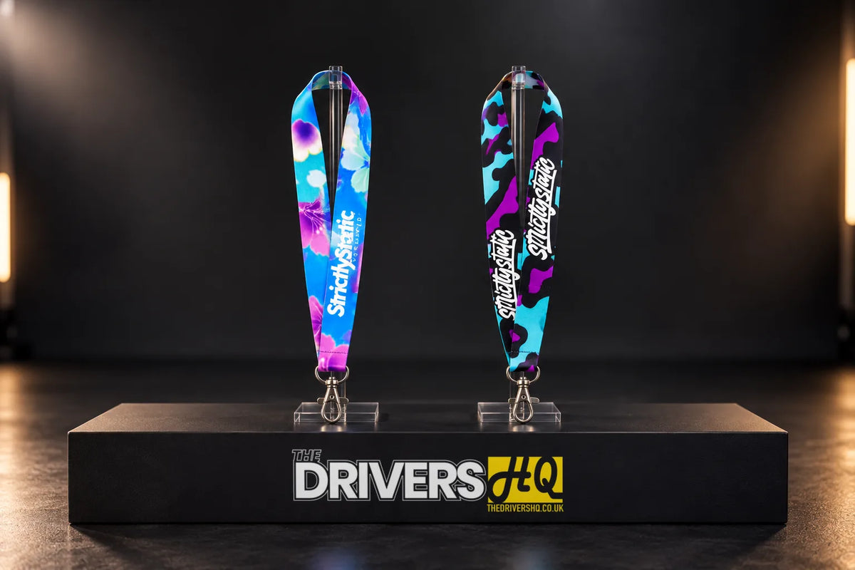 Strictly Static Blossom and Blue Leopard lanyards on clear stands on a black display plinth