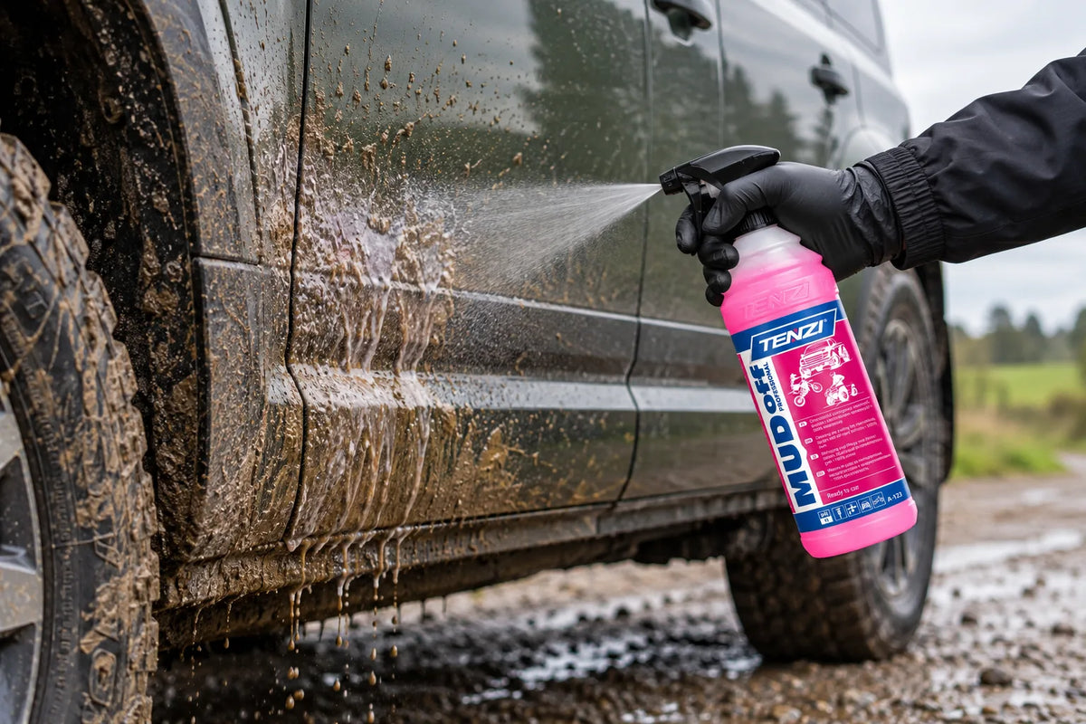 Tenzi Mud Off Professional being sprayed onto the muddy side of a dark SUV