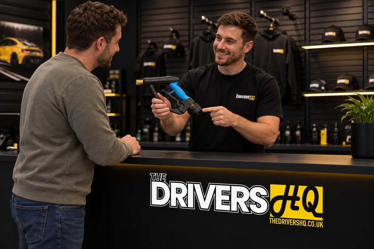 The Drivers HQ team member at the store counter showing a customer a DTLR reverse short trigger gun fitted with a Better Detailing Karcher stubby adapter
