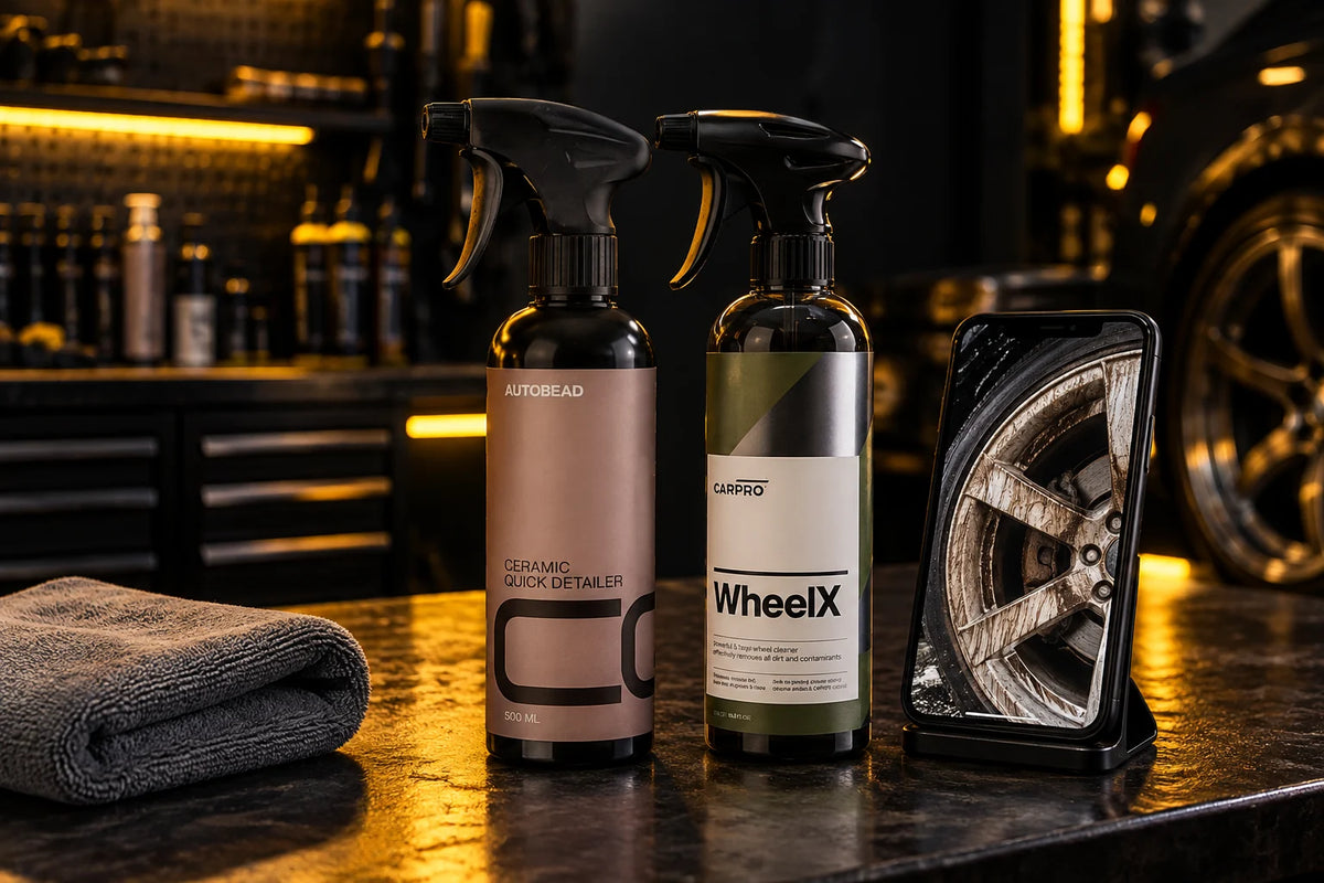 AutoBead Ceramic Quick Detailer and CarPro WheelX on a studio workbench beside a phone showing a dirty alloy wheel