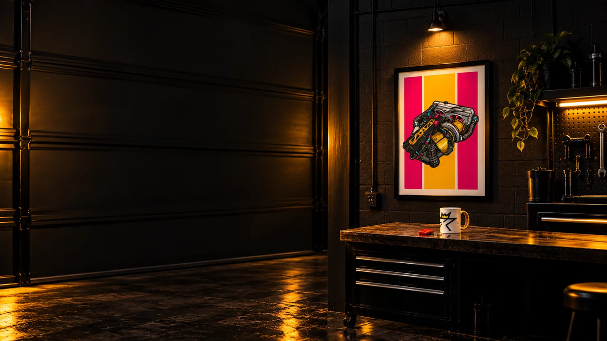 The Engine V2 art poster on a garage wall above a workbench with a FibreKing mug and a red jerry can keyring