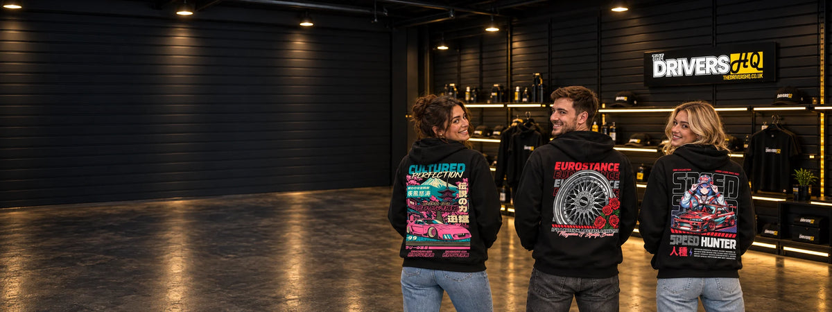 Three friends in The Drivers HQ store wearing the EuroStance Legends Club Cultured RX-7, BBS & Roses and Speed Hunter Dope hoodies, back prints to the camera