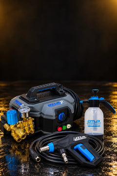 Pressure washer setup: the Kiam DTLR 2 Pro with its hose coiled, the DTLR 2.0 Pro trigger gun and a DTLR Spray Cannon on a wet detailing bay floor
