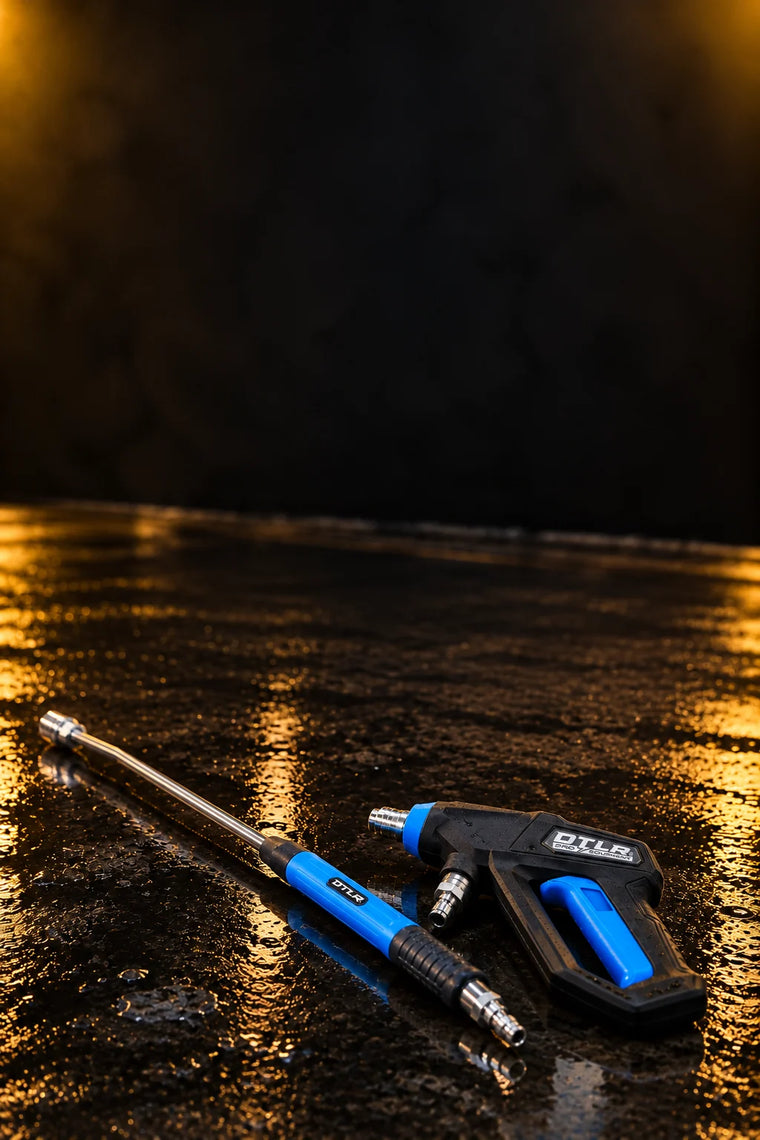DTLR 2.0 Pro trigger gun and DTLR 2.0 extension lance lying on a wet detailing bay floor