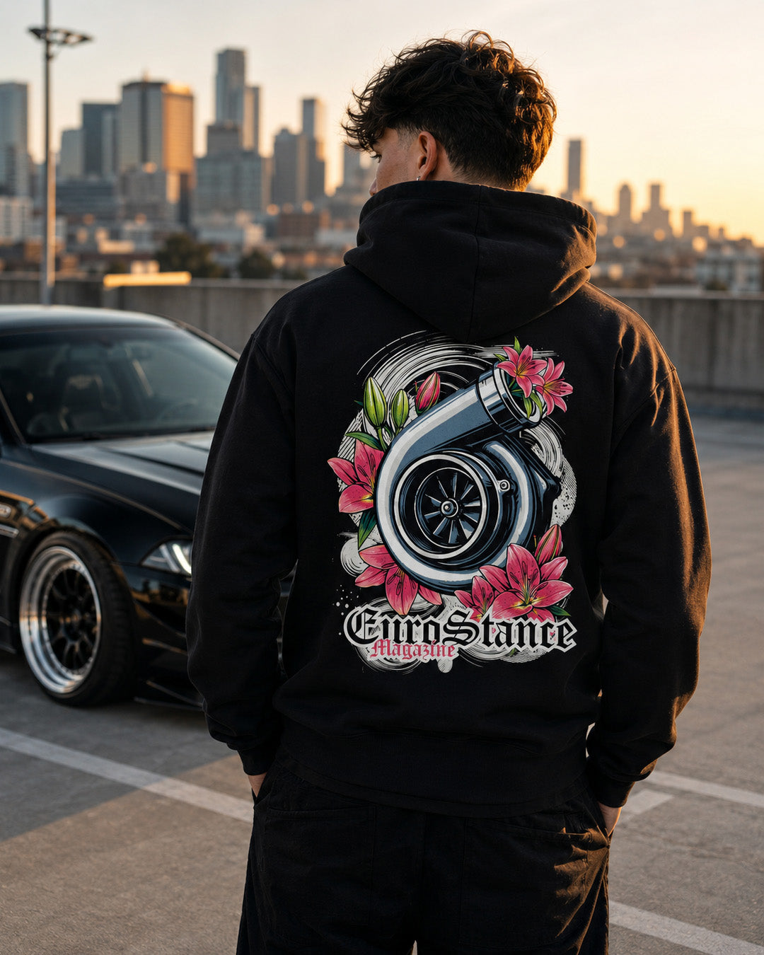 EuroStance TurboCharged Hoodie worn at sunset, black hoodie with turbo and pink lily back print