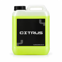 Yum Citrus pre wash 5 litre jerrycan with lime green liquid and a black CITRUS label, studio photo on white