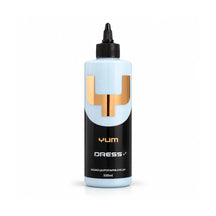 Yum Dress V2 rubber and trim dressing 500ml pale blue bottle with a black label and copper Y mark, studio photo on white