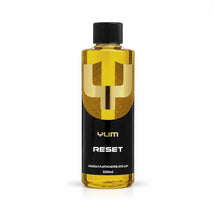 Yum Reset acidic shampoo 500ml bottle with golden yellow liquid, a black screw cap and gold Y mark, studio photo on white
