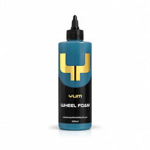 Yum Wheel Foam wheel cleaner 500ml bottle with steel blue liquid, a black nozzle cap and gold Y mark, studio photo on white